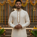Man wearing a white kurta in a South Indian festive setting
